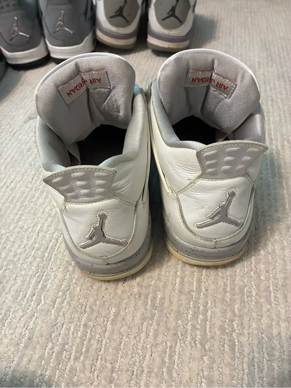 Jordan’s Nike White & Red Air Jordan 4 Retro Sneakers